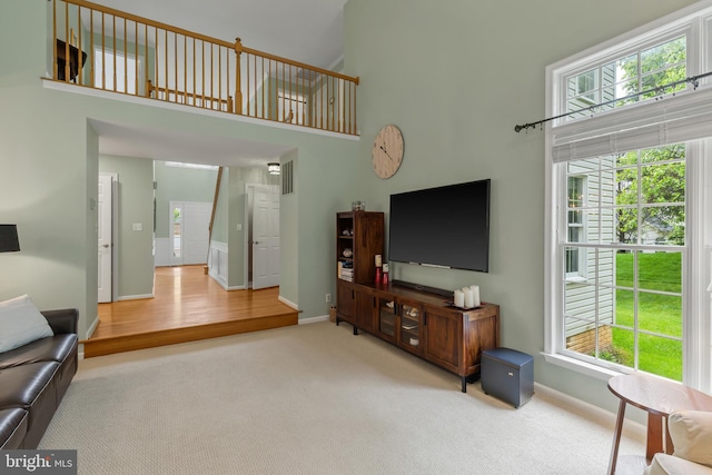7071 Garden Walk, Columbia, MD 21044 - carpeted living room featuring a high ceiling and baseboards