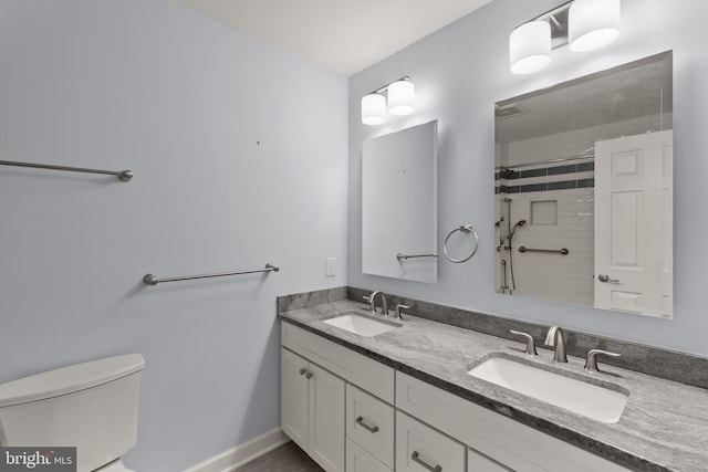 7071 Garden Walk, Columbia, MD 21044 - full bath with toilet, double vanity, tiled shower, and baseboards