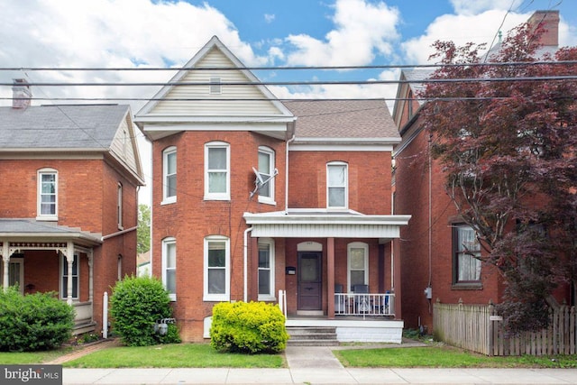 449 Carlisle St, Hanover, PA 17331 - townhome / multi-family property with a porch, brick siding, and fence