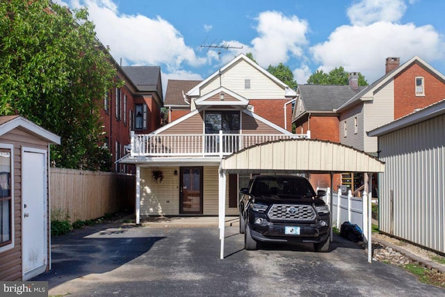 449 Carlisle St, Hanover, PA 17331 - townhome / multi-family property with asphalt driveway, fence, and a detached carport