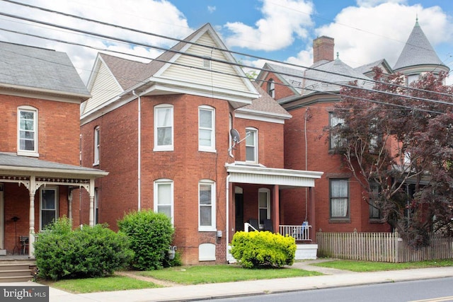 449 Carlisle St, Hanover, PA 17331 - view of front of home with a porch, brick siding, and fence
