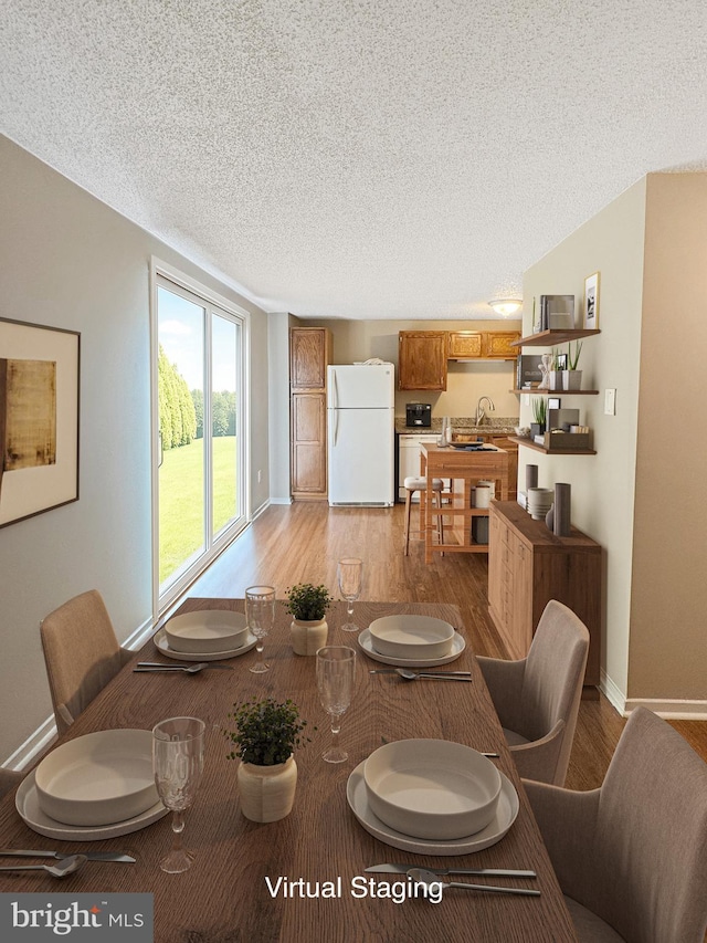 7 E Hart St, Winchester, VA 22601 - dining space featuring light wood-style floors, a textured ceiling, and baseboards