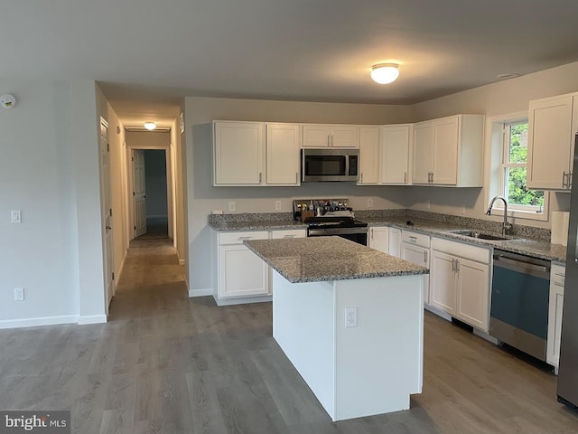 17 Apple Orchard Trl, Berkeley Springs, WV 25411 - kitchen with stainless steel appliances, a sink, stone counters, white cabinets, and a kitchen island