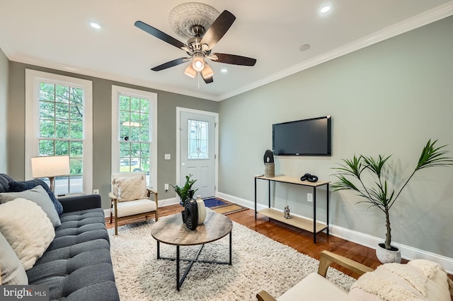 living room with wood finished floors, baseboards, crown molding, ceiling fan, and recessed lighting