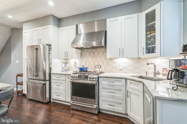 1153 N Hancock St, Philadelphia, PA 19123 - kitchen featuring stainless steel appliances, wall chimney range hood, light stone counters, glass insert cabinets, and dark wood-type flooring
