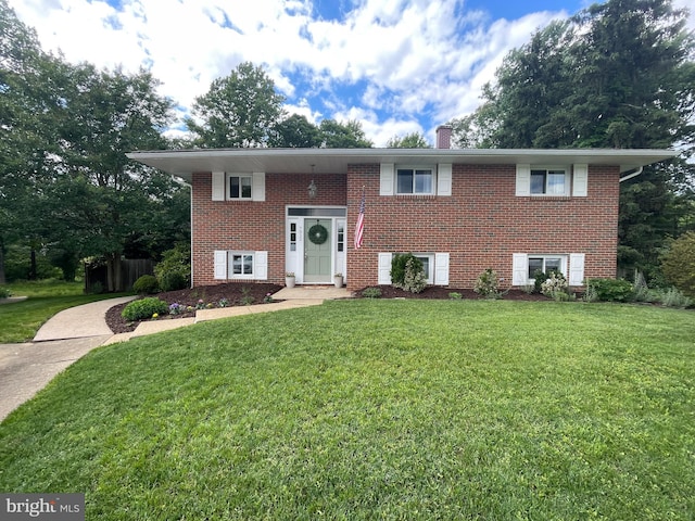 7912 Glengary Ct, Glen Burnie, MD 21061 - raised ranch featuring a front lawn, brick siding, and a chimney