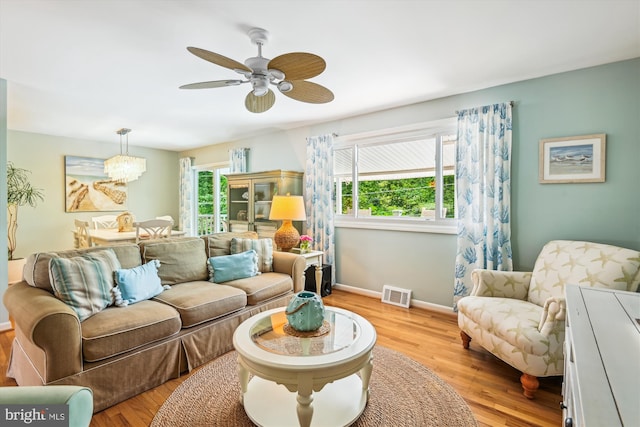 7912 Glengary Ct, Glen Burnie, MD 21061 - living area with light wood-type flooring, plenty of natural light, baseboards, and ceiling fan