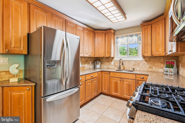 7912 Glengary Ct, Glen Burnie, MD 21061 - kitchen featuring appliances with stainless steel finishes, a sink, decorative backsplash, and brown cabinets
