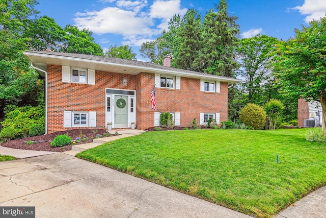 7912 Glengary Ct, Glen Burnie, MD 21061 - bi-level home featuring a chimney, a front yard, cooling unit, and brick siding