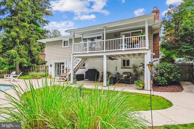 7912 Glengary Ct, Glen Burnie, MD 21061 - rear view of house featuring a patio, stairway, and a chimney
