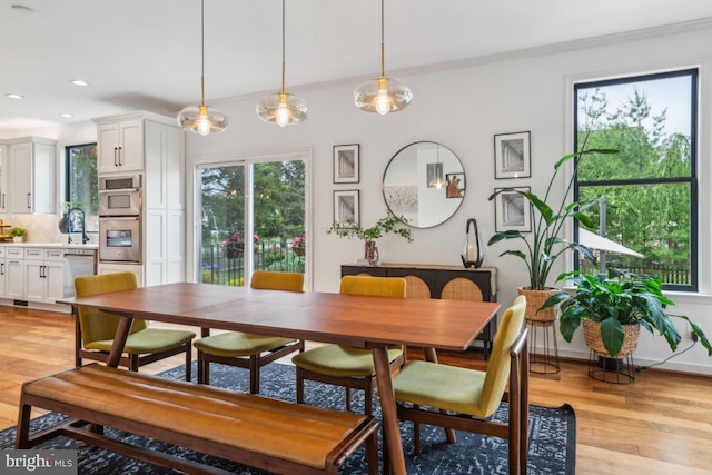 42004 Donnington Pl, Ashburn, VA 20148 - dining area featuring light wood finished floors, recessed lighting, and crown molding