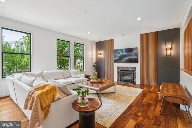 42004 Donnington Pl, Ashburn, VA 20148 - living room with a high end fireplace, wood finished floors, and recessed lighting