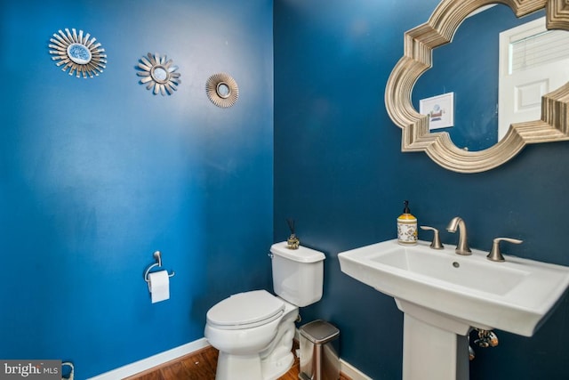 42004 Donnington Pl, Ashburn, VA 20148 - bathroom with baseboards, wood finished floors, toilet, and a sink
