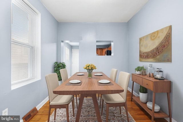 dining area featuring wood finished floors and baseboards