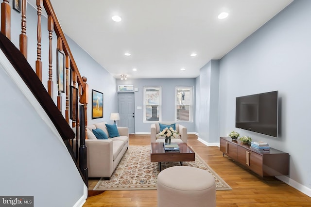 living area with stairway, light wood-style flooring, recessed lighting, and baseboards
