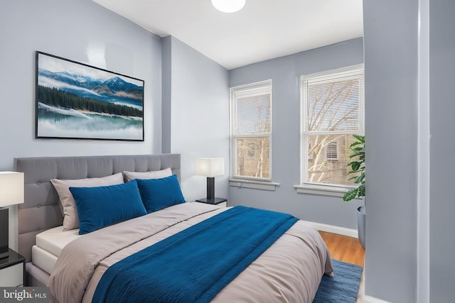 bedroom with wood finished floors and baseboards