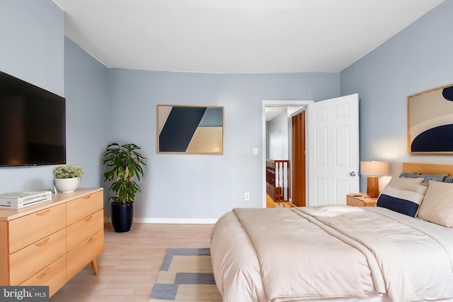 bedroom featuring light wood-style flooring and baseboards