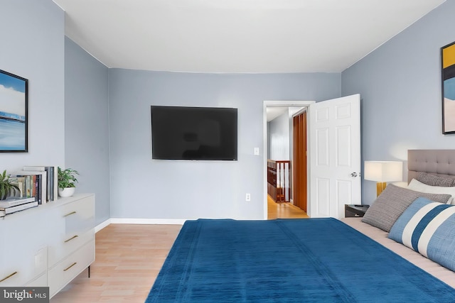bedroom featuring light wood-type flooring and baseboards