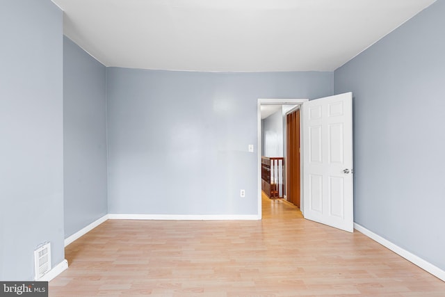 unfurnished room with light wood finished floors and baseboards