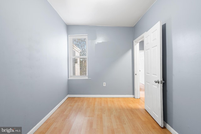 unfurnished room with wood finished floors and baseboards