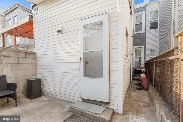 doorway to property with fence and a patio