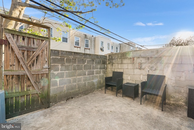 view of patio featuring fence and a gate