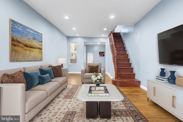 living room featuring stairway, recessed lighting, light wood finished floors, and baseboards