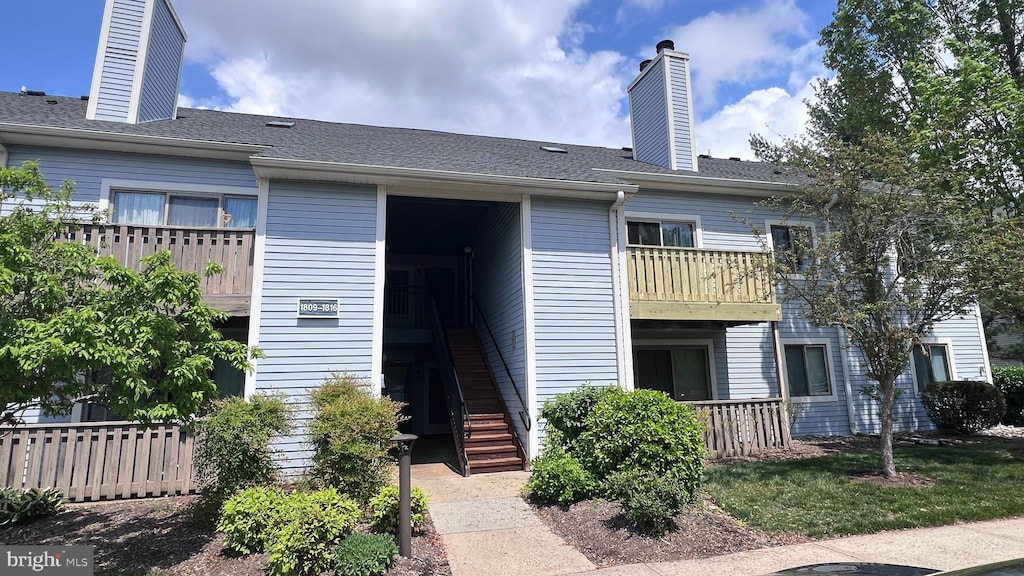 1816 Aspen Dr, Plainsboro, NJ 08536 - view of front facade featuring a chimney, stairway, a balcony, and fence