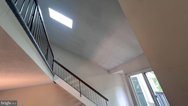 stairs with a textured ceiling