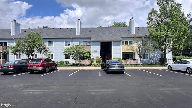 view of building exterior featuring uncovered parking