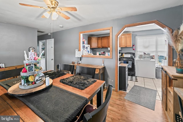 dining space featuring ceiling fan and light wood-style flooring