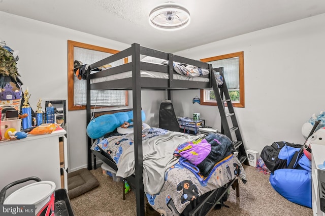 bedroom featuring carpet and baseboards
