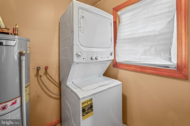 washroom featuring water heater and stacked washer and clothes dryer