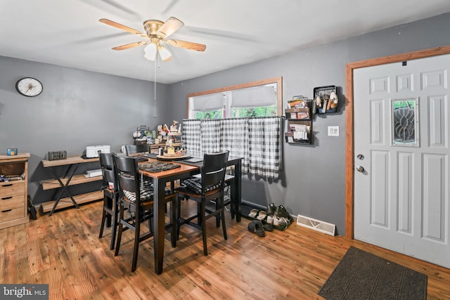 dining room featuring ceiling fan, wood finished floors, and a desk
