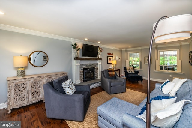 living area featuring ornamental molding, wood finished floors, a stone fireplace, recessed lighting, and baseboards