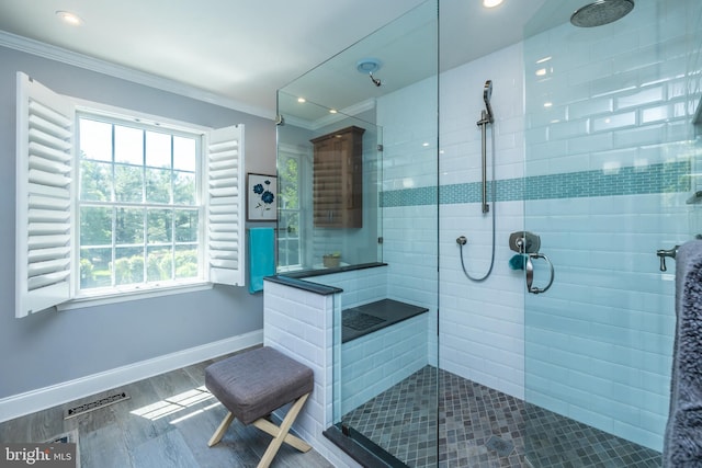 bathroom with crown molding, tiled shower, baseboards, wood finished floors, and recessed lighting