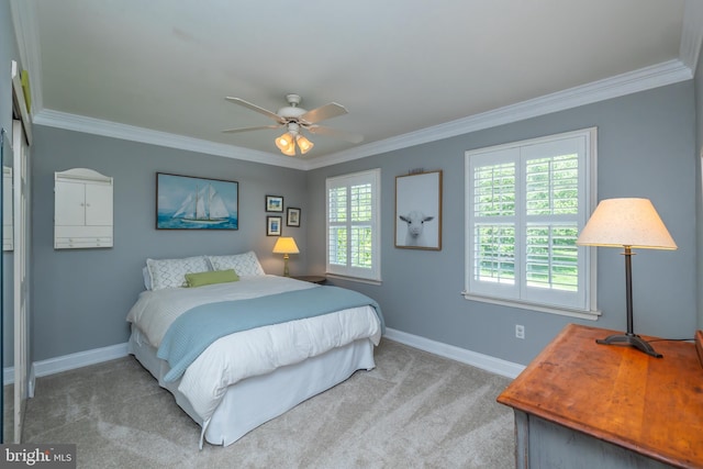 bedroom with baseboards, crown molding, carpet, and a ceiling fan