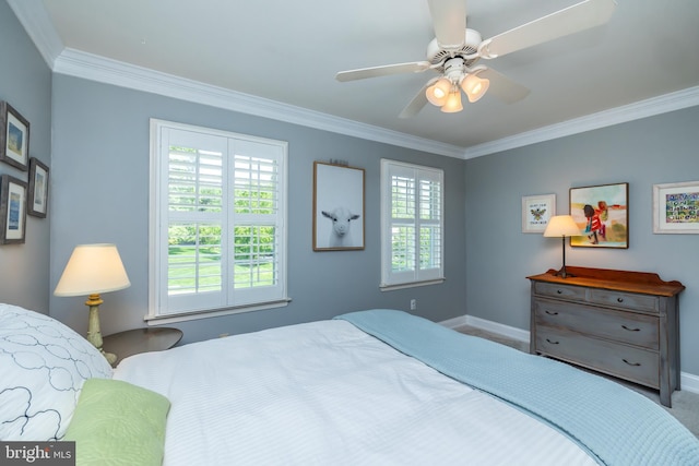 carpeted bedroom featuring baseboards, ornamental molding, and a ceiling fan
