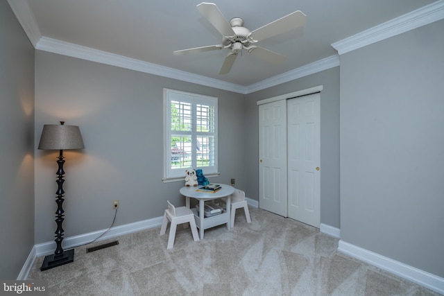 carpeted home office with crown molding, ceiling fan, and baseboards