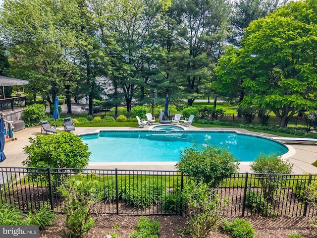 view of swimming pool featuring fence, a patio, and a pool with connected hot tub