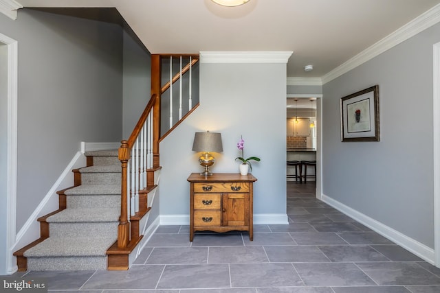 staircase featuring crown molding, tile patterned floors, and baseboards
