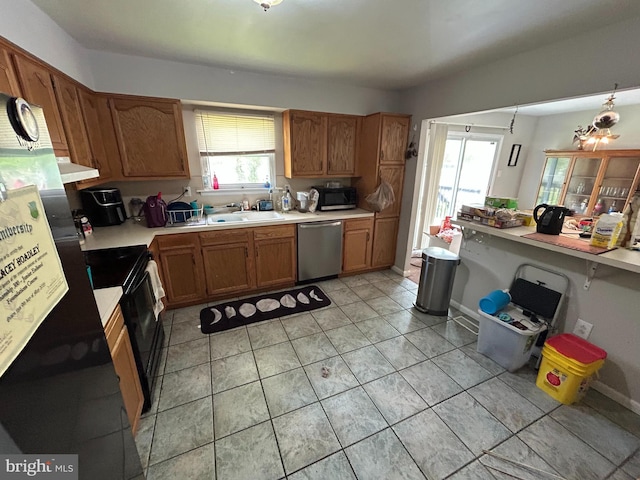 168 Garden Ave, Browns Mills, NJ 08015 - kitchen with black appliances, light countertops, a sink, under cabinet range hood, and brown cabinetry