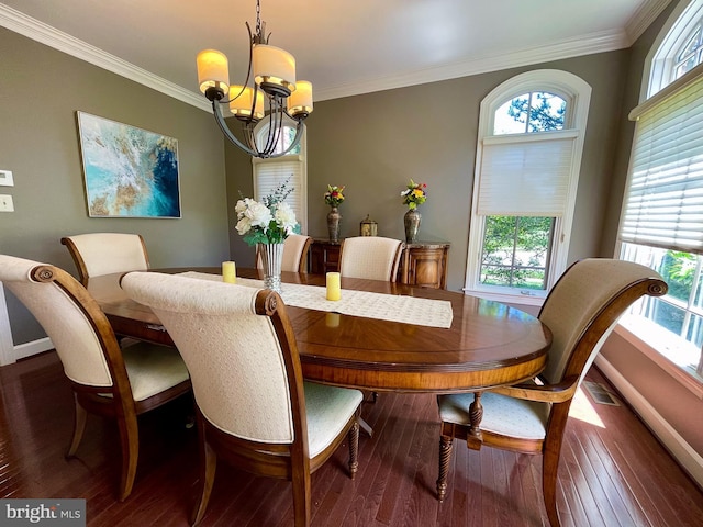 dining space with a chandelier, hardwood / wood-style flooring, crown molding, and baseboards