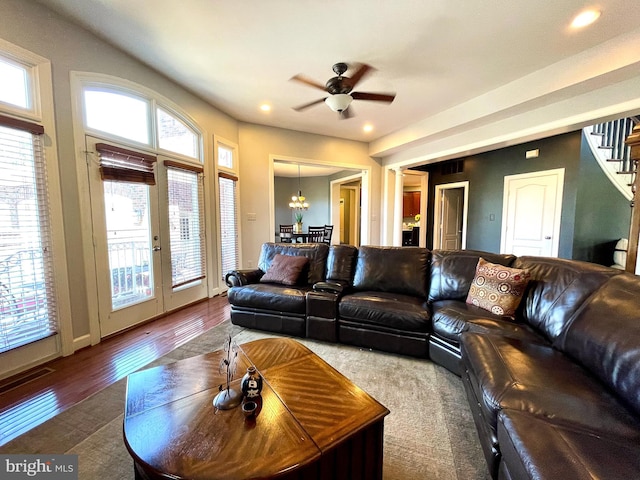 living area featuring wood finished floors, stairs, recessed lighting, ceiling fan, and a chandelier