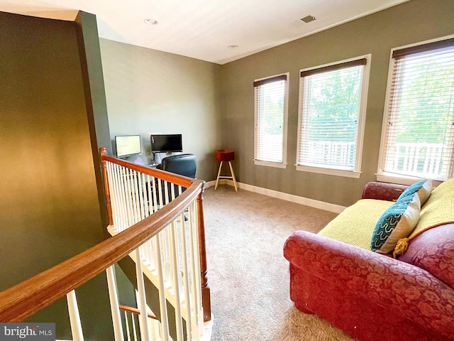 carpeted living room with baseboards