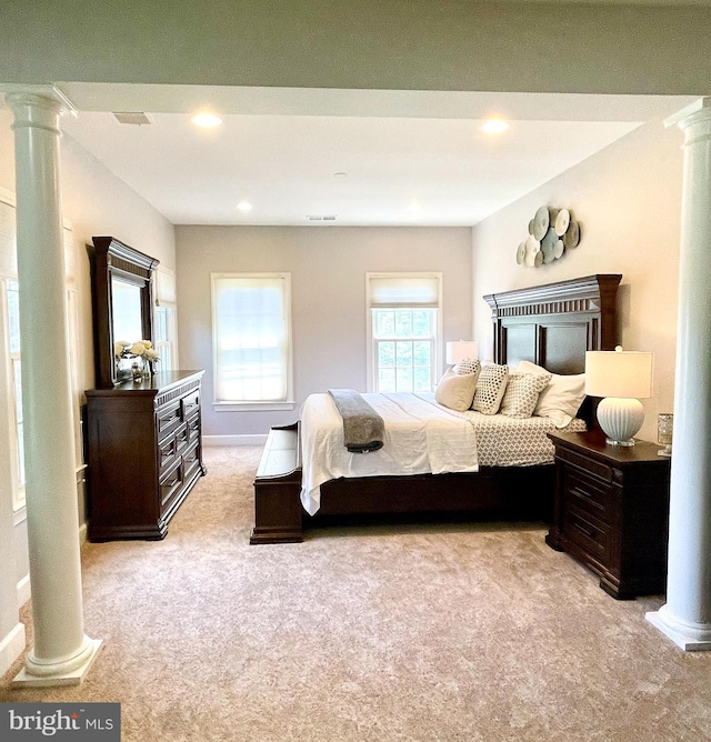 bedroom featuring decorative columns, light carpet, recessed lighting, and baseboards