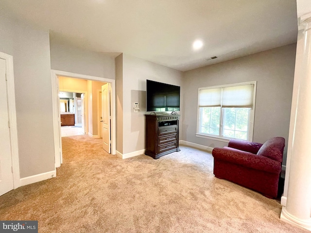 sitting room featuring carpet flooring and baseboards