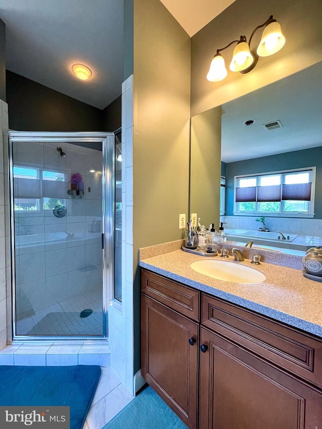 bathroom with a stall shower and vanity