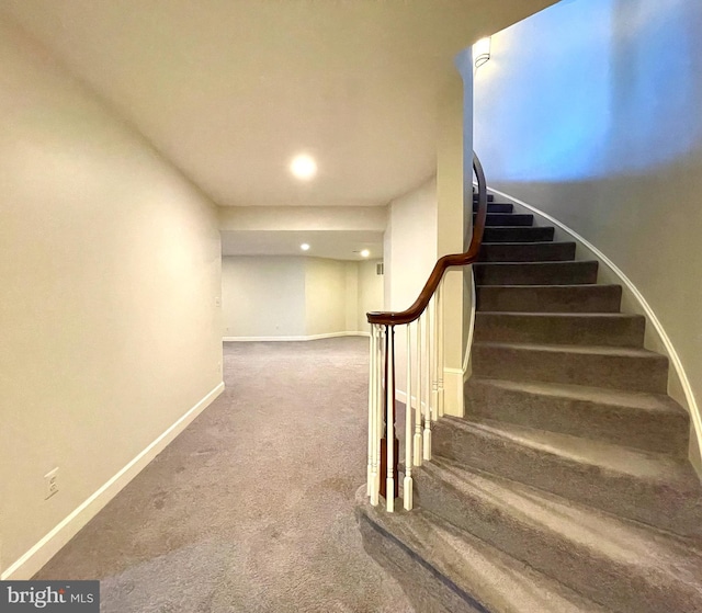 stairway with baseboards, carpet floors, and recessed lighting
