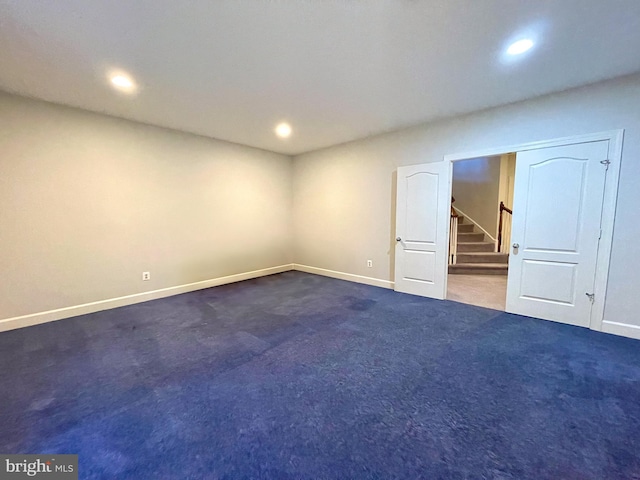 spare room featuring baseboards, recessed lighting, carpet flooring, and stairs
